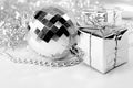 Disco ball toy, silver little gifts, shiny tinsel, beads. New year decorations on white background. Christmas concept Royalty Free Stock Photo