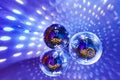 Disco balls with bright rays and highlights at the night disco in the club. Background image Royalty Free Stock Photo