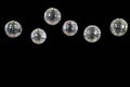 Disco balls in front of black