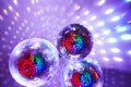 Disco balls with mirror reflections and lights at a night party in a bar or club