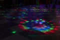 Disco on dance floor. Flower spots on floor. Color music indoors