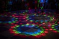 Disco on dance floor. Flower spots on floor. Color music indoors