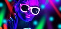 Disco dancer in neon light in night club Fashion model woman in neon light, portrait of beautiful girl with fluorescent make-up Royalty Free Stock Photo