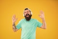 Disco sound. Bearded man relaxing with melodious sound on yellow background. Hipster wearing earphones playing