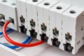 Disconnected ports of automatic circuit breakers closeup in the white plastic mounting box Royalty Free Stock Photo