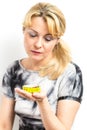 Disconsolate young woman looking at a tape measure Royalty Free Stock Photo