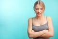 Discontent female, being upset, isolated over blue studio background.