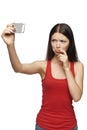 Discontent woman taking pictures of herself through cellphone