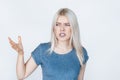 Discontent young woman on white background.