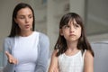 Discontented young mother scolding little daughter expresses displeasure Royalty Free Stock Photo