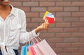 Discount, bonuses and cashback from stores. African american girl with bags holds credit and discount cards in hand