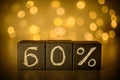 60% discount chalk written on black cubes on blurred bokeh background