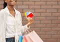 Discount and credit cards for purchases. Smiling female holding cards and packages in her hand