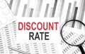 DISCOUNT RATE text on paper with calculator,magnifier ,pen on graph background Royalty Free Stock Photo