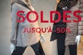 discount sign SOLDES jusqu'a 50% in french, ) on the window of fashion store