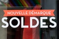 Discount sign `SOLDES nouvelle demarque` in french, the traduction of sales, new markdown on window in french fashion store Royalty Free Stock Photo