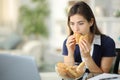 Discouraged anxious woman eating bakery