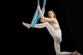 Discouraged girl tries to do stretching exercise in sports hammock. Air gymnastics.Unsuccessful attempt to master twine