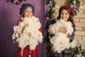 Discover the beauty of winter. Small girls with Christmas decoration. Happy children celebrate Christmas new year. Small Royalty Free Stock Photo