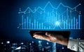 Innovative Data Visualization with Graphs and Charts on Tablet Device Against a City Skyline Background at Night Scalp Royalty Free Stock Photo