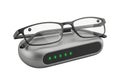 Modern smart glasses charging on sleek dock with indicator lights Royalty Free Stock Photo