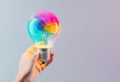 Creative hand holds a light bulb, sparking colorful ideas, AI Generated