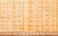 Wooden Board Empty Table with Bamboo Basket in the Background Royalty Free Stock Photo