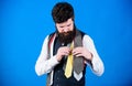 Discover trendy mens fashion in our shop. Bearded man choosing luxury necktie in menswear shop. Shop assistant offering