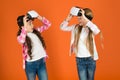 Discover virtual reality. Kids girls play virtual reality game. Friends interact in vr. Explore alternative reality Royalty Free Stock Photo