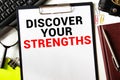 Discover your strengths- business concept of entrepreneur management message on wood background with paper clips