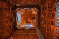 Discovering beautiful Paris: photo of base support legs of the Eiffel tower. Bottom view. Iron steel metal structure. The dense Royalty Free Stock Photo