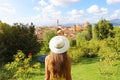 Discovering Florence. Back view of young tourist girl looking at Florence cityscape between trees in park. Tourism in Tuscany