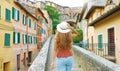 Discovering Italy. Back view of young attractive woman walking in old Italian city Royalty Free Stock Photo