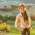 Adventure woman hiker in hat enjoying evening in Tuscany