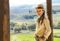 Smiling adventure woman hiker in hat hiking in Tuscany