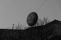 Discrepancy: On the roof of an old, 200 year old house, there is a modern satellite dish. Royalty Free Stock Photo