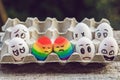 Discrimination gay concept. Two rainbow eggs in the form of a homosexual couple. And condemning people around