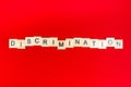 Discrimination- word composed fromwooden blocks letters on red background, copy space for ad text