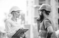 Discuss progress project. Construction project inspecting. Safety inspector concept. Woman inspector and bearded brutal Royalty Free Stock Photo