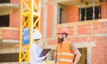 Discuss progress project. Safety inspector concept. Woman inspector and bearded brutal builder discuss construction Royalty Free Stock Photo