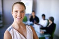 Discussing business strategy. Portrait of a businesswoman standing in front of her colleagues during a meeting. Royalty Free Stock Photo