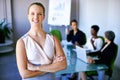 Discussing business strategy. Portrait of a businesswoman standing in front of her colleagues during a meeting. Royalty Free Stock Photo