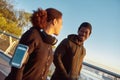 Discussing jogging. Happy african male athlet talking with his girlfriend and smiling after morning jog. Couple in black Royalty Free Stock Photo