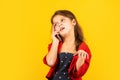 Discussing news. Nice talk. Happy childhood. Small child with smartphone. Cheerful little girl yellow background. Girl