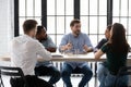 Business team of five millennial members brainstorming at office boardroom