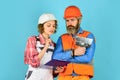 Discussing renovation with contractor. Plastering works. Couple look documents. Woman and man safety hard hat. Couple Royalty Free Stock Photo