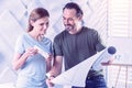 Friendly architects smiling while looking at the new blueprint Royalty Free Stock Photo