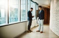 Discussing what needs to be discussed. two young businessmen using a digital tablet together in a modern office. Royalty Free Stock Photo