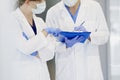 Discussion of two doctors in protective gloves Royalty Free Stock Photo