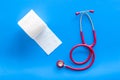 Proctology concept with toilet paper roll and stethoscope on blue background top view Royalty Free Stock Photo